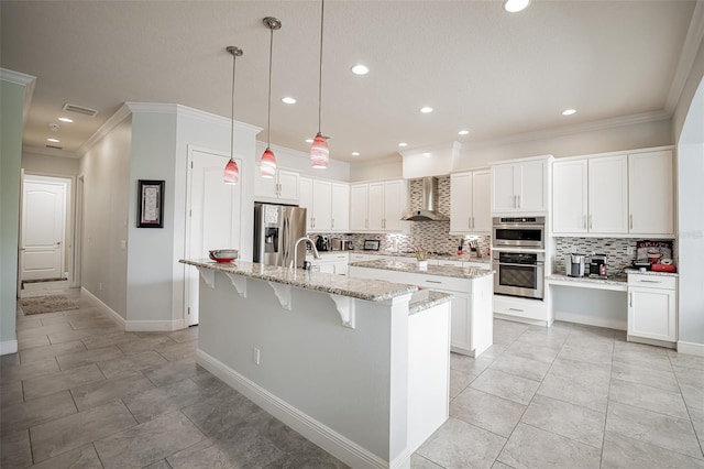kitchen with stainless steel appliances, a center island with sink, wall chimney range hood, decorative backsplash, and crown molding