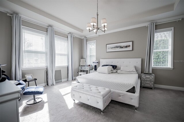 bedroom with a chandelier, carpet flooring, baseboards, and a tray ceiling
