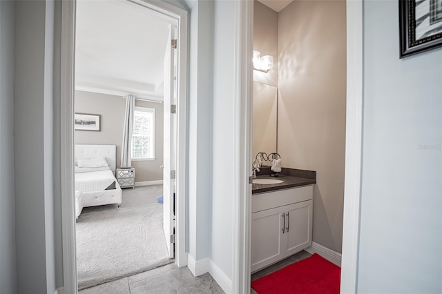 bathroom featuring baseboards, vanity, and ornamental molding