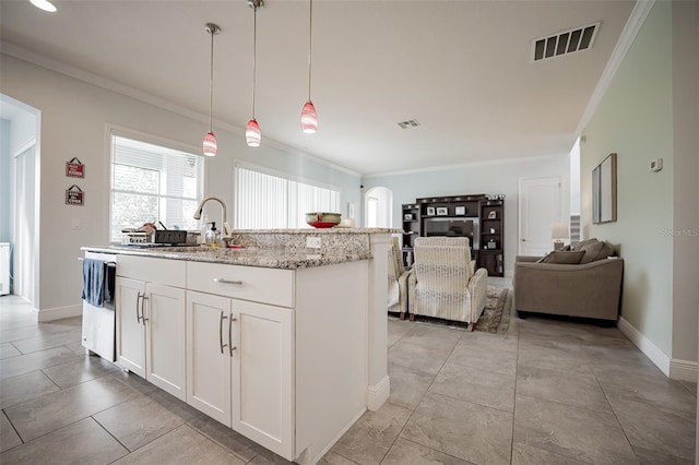 kitchen featuring arched walkways, crown molding, a sink, white cabinetry, and dishwashing machine