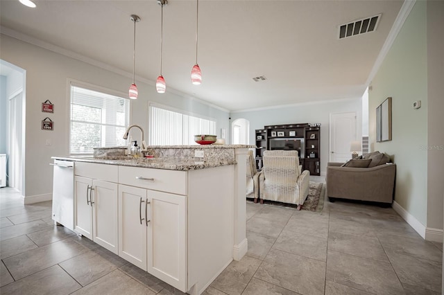 kitchen with a sink, white dishwasher, arched walkways, ornamental molding, and pendant lighting