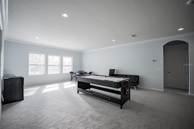 game room with carpet floors, crown molding, arched walkways, baseboards, and recessed lighting