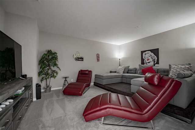 living room featuring carpet flooring and baseboards