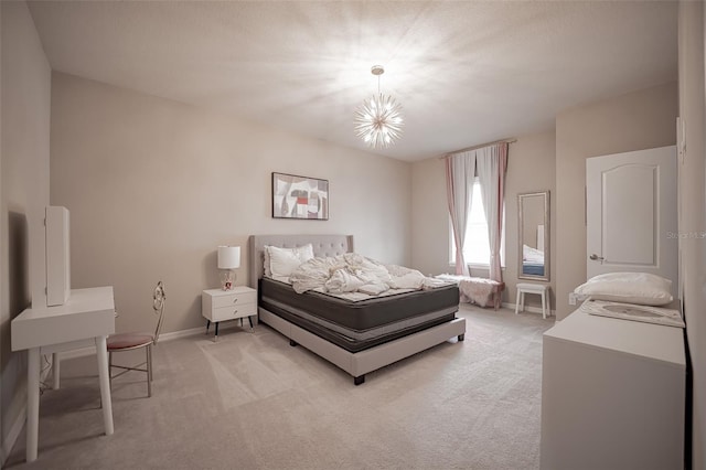 bedroom with light colored carpet and baseboards