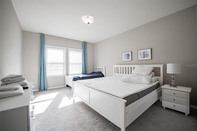 bedroom featuring carpet and baseboards