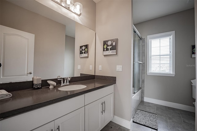 full bath featuring baseboards, vanity, and combined bath / shower with glass door