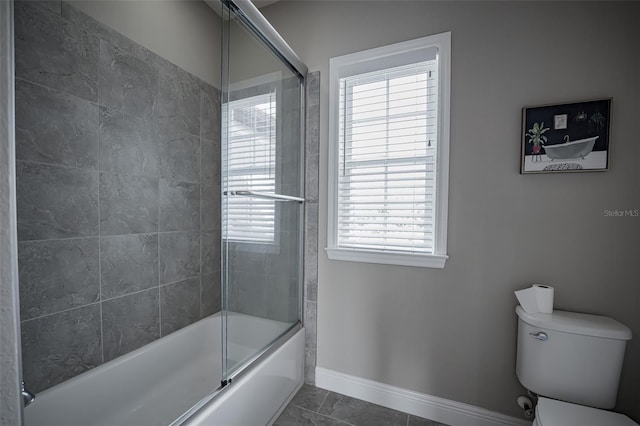 full bath featuring baseboards, toilet, and combined bath / shower with glass door
