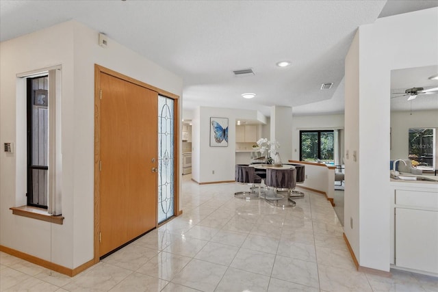 2652 Bent Hickory Cir, Longwood, FL 32779 - foyer entrance featuring baseboards, a ceiling fan, and light marble finish flooring