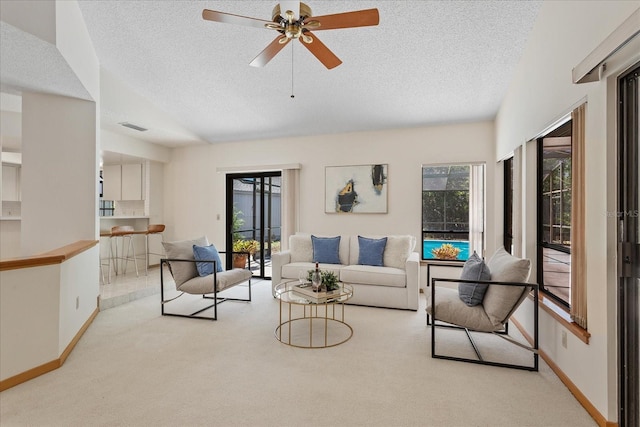 2652 Bent Hickory Cir, Longwood, FL 32779 - carpeted living area with a textured ceiling, baseboards, and ceiling fan