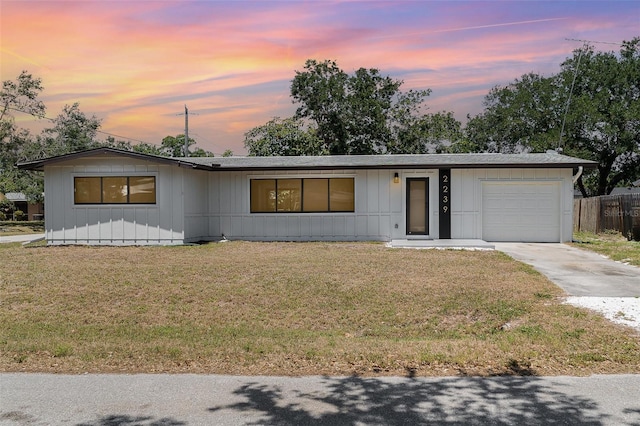 ranch-style home featuring a garage and concrete driveway