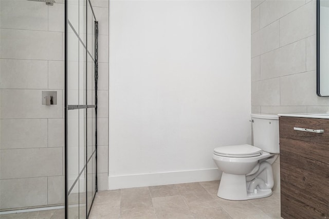 bathroom featuring a stall shower, toilet, vanity, and tile patterned floors