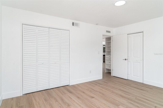 unfurnished bedroom with light wood finished floors and baseboards
