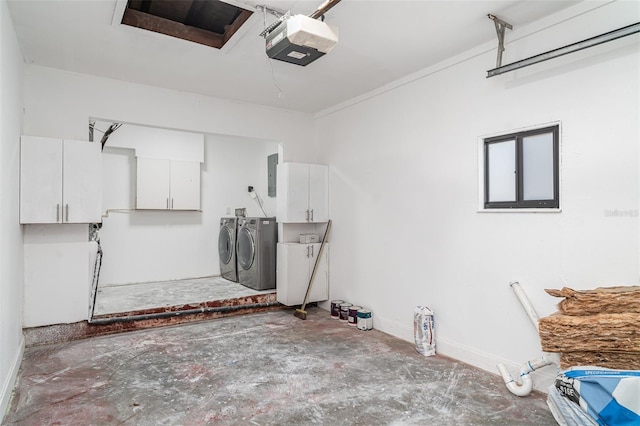 garage with washing machine and clothes dryer, a garage door opener, electric panel, and baseboards