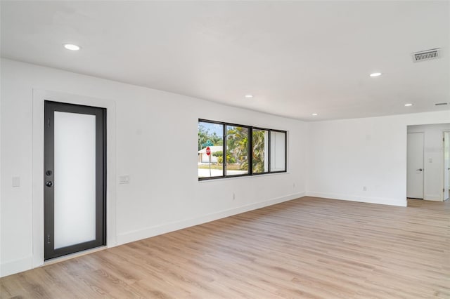 spare room with light wood-style flooring, recessed lighting, and baseboards