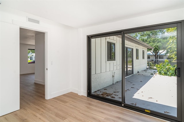 empty room featuring light wood-style flooring and baseboards