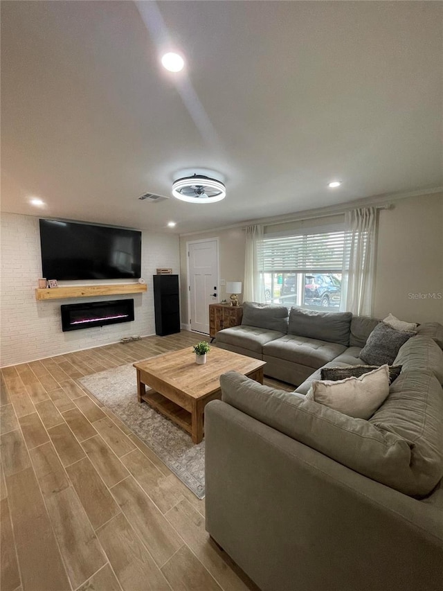 9153 86th Ave, Seminole, FL 33777 - living room with wood finished floors and a glass covered fireplace