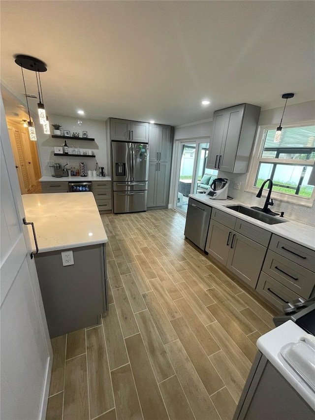 9153 86th Ave, Seminole, FL 33777 - kitchen featuring appliances with stainless steel finishes, gray cabinetry, a sink, light wood-style flooring, and recessed lighting