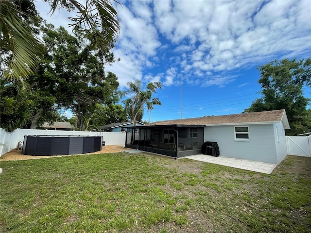 9153 86th Ave, Seminole, FL 33777 - back of house featuring a sunroom, a pool, and concrete block siding