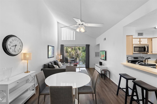 3900 Southpointe Dr Unit 127, Orlando, FL 32822 - dining space with ceiling fan, dark wood finished floors, high vaulted ceiling, and baseboards