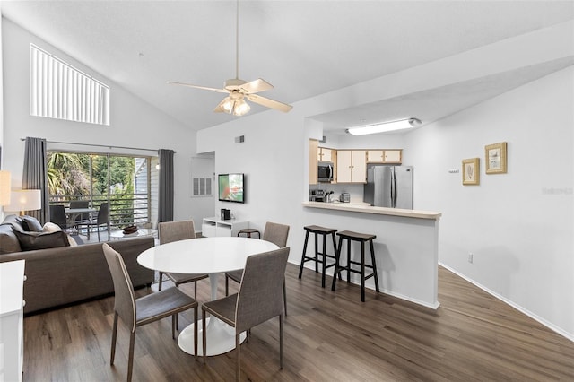 3900 Southpointe Dr Unit 127, Orlando, FL 32822 - dining area with dark wood-style floors, ceiling fan, high vaulted ceiling, and baseboards
