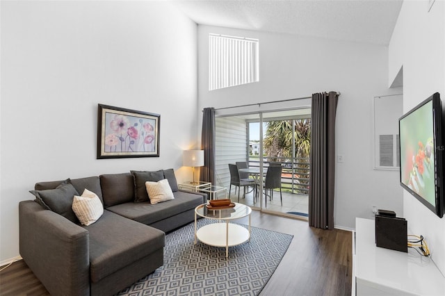 3900 Southpointe Dr Unit 127, Orlando, FL 32822 - living room featuring wood finished floors, a high ceiling, and baseboards