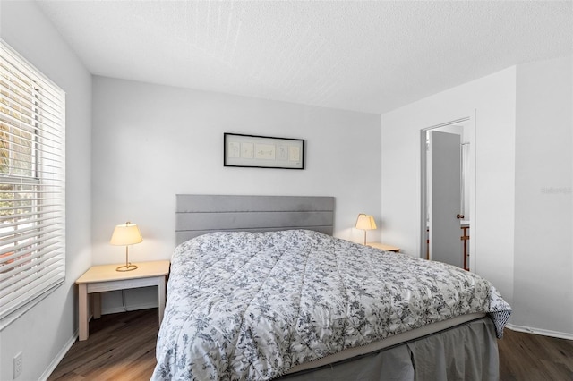 3900 Southpointe Dr Unit 127, Orlando, FL 32822 - bedroom with wood finished floors, a textured ceiling, and baseboards