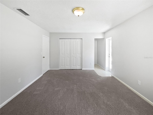 6623 Baybrooks Cir, Temple Terrace, FL 33617 - unfurnished bedroom featuring carpet floors, a closet, baseboards, and a textured ceiling