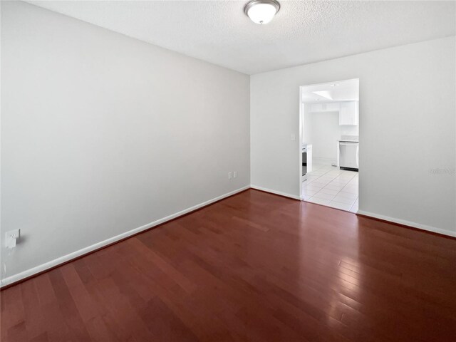 6623 Baybrooks Cir, Temple Terrace, FL 33617 - unfurnished room with light wood-type flooring, baseboards, and a textured ceiling