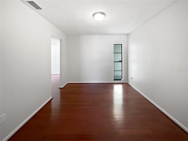 6623 Baybrooks Cir, Temple Terrace, FL 33617 - empty room featuring a textured ceiling, wood finished floors, and baseboards
