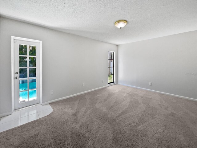 6623 Baybrooks Cir, Temple Terrace, FL 33617 - spare room featuring carpet floors, a textured ceiling, and baseboards