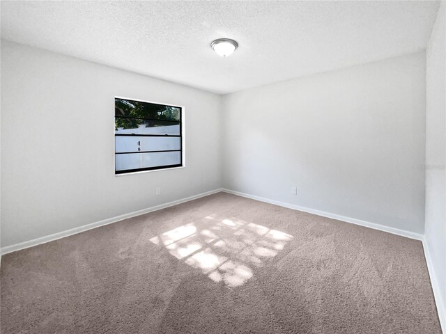 6623 Baybrooks Cir, Temple Terrace, FL 33617 - unfurnished room featuring carpet floors, a textured ceiling, and baseboards