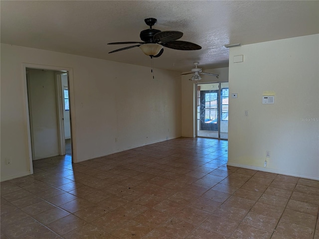 155 Summerset Dr, Punta Gorda, FL 33982 - tiled spare room with a ceiling fan, baseboards, and a textured ceiling