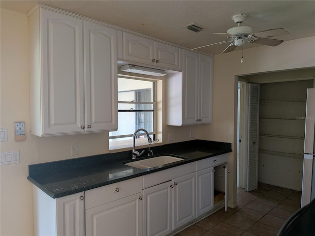 155 Summerset Dr, Punta Gorda, FL 33982 - kitchen with a sink, white cabinets, tile patterned flooring, and refrigerator