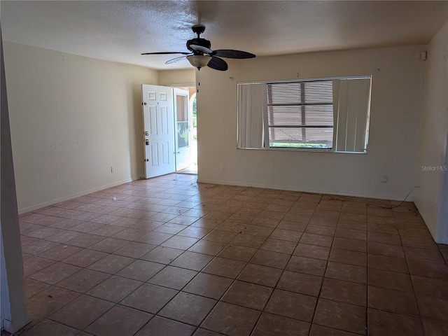 155 Summerset Dr, Punta Gorda, FL 33982 - tiled empty room with a ceiling fan, baseboards, and a textured ceiling