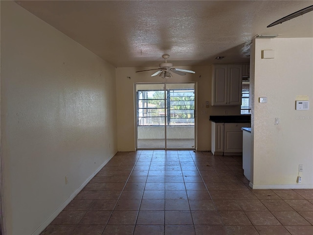 155 Summerset Dr, Punta Gorda, FL 33982 - unfurnished dining area featuring a ceiling fan, tile patterned floors, baseboards, and a textured ceiling