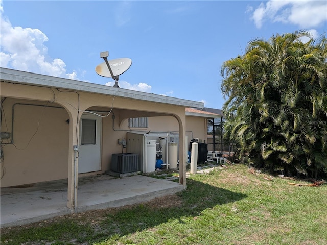 155 Summerset Dr, Punta Gorda, FL 33982 - back of property featuring a yard, a patio, stucco siding, and central AC unit