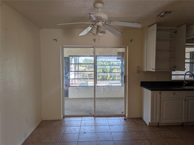 155 Summerset Dr, Punta Gorda, FL 33982 - unfurnished dining area with a sink, baseboards, a ceiling fan, and light tile patterned floors