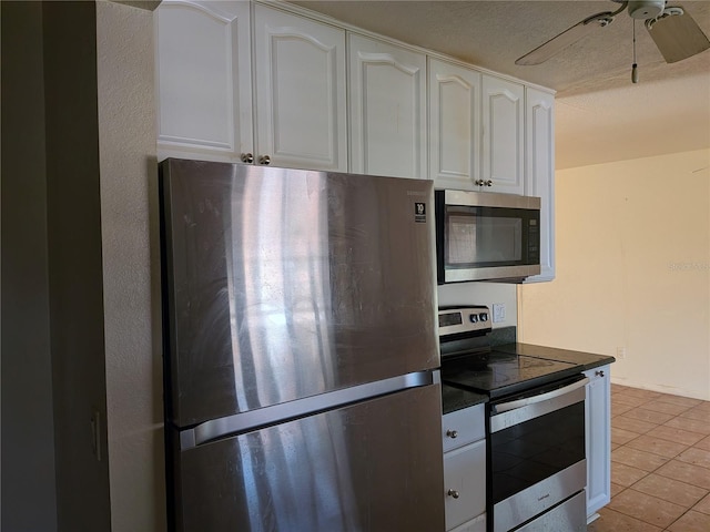 155 Summerset Dr, Punta Gorda, FL 33982 - kitchen featuring appliances with stainless steel finishes, dark countertops, white cabinetry, light tile patterned floors, and ceiling fan