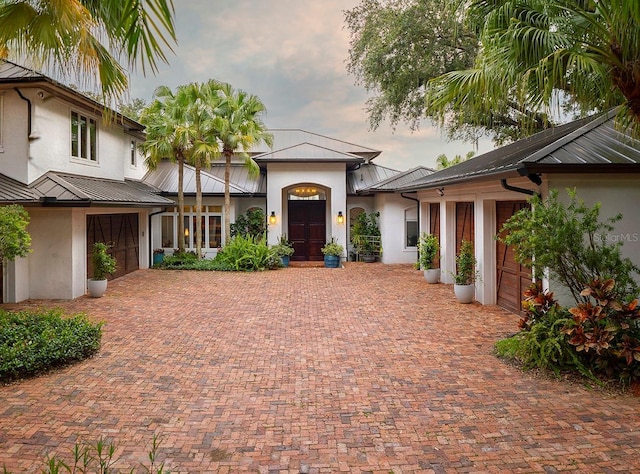 9724 Chestnut Ridge Dr, Windermere, FL 34786 - view of front of home featuring a standing seam roof, stucco siding, and metal roof