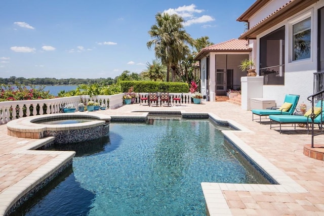 9724 Chestnut Ridge Dr, Windermere, FL 34786 - view of swimming pool with a patio area, a pool with connected hot tub, a sunroom, and a water view