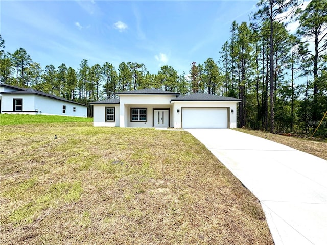1795 W Linden Dr, Citrus Springs, FL 34434 - view of front of home with a garage, driveway, stucco siding, and a front yard