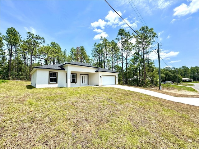 1795 W Linden Dr, Citrus Springs, FL 34434 - view of front of house with stucco siding, concrete driveway, an attached garage, a front lawn, and view of wooded area