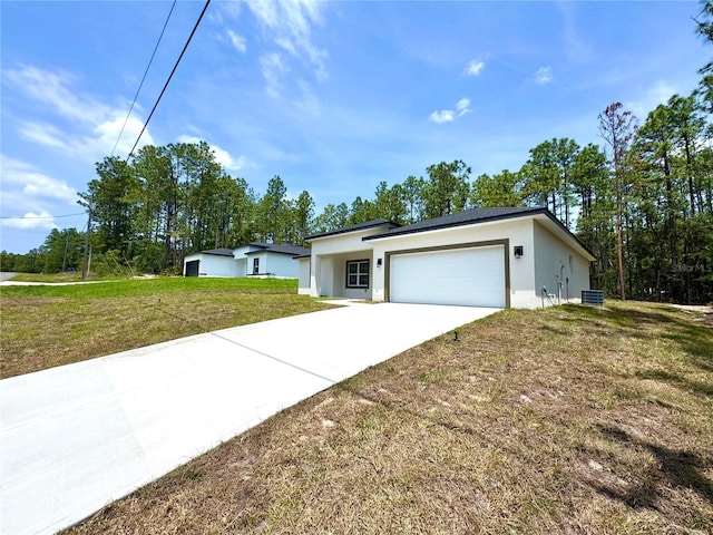 1795 W Linden Dr, Citrus Springs, FL 34434 - view of front of property with stucco siding, a garage, driveway, and a front lawn