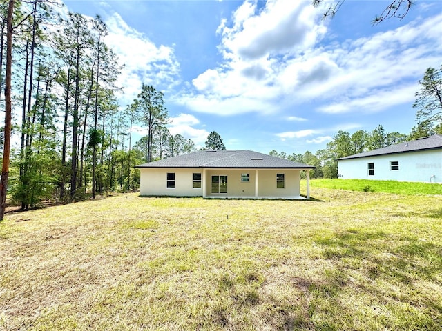 1795 W Linden Dr, Citrus Springs, FL 34434 - rear view of property featuring a yard and stucco siding