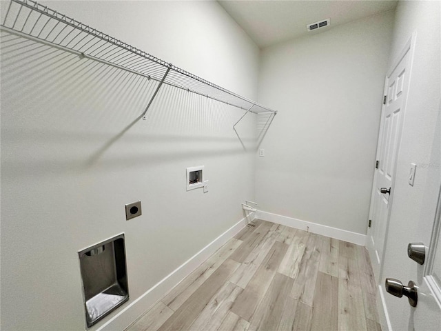 1795 W Linden Dr, Citrus Springs, FL 34434 - laundry area featuring electric dryer hookup, light wood-style flooring, hookup for a washing machine, and baseboards