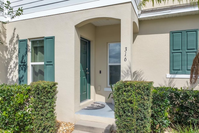 316 Primrose Dr, Davenport, FL 33837 - view of exterior entry featuring stucco siding