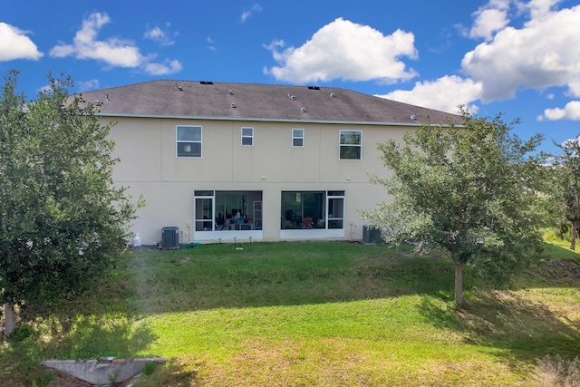 316 Primrose Dr, Davenport, FL 33837 - back of property with central AC unit, stucco siding, and a yard