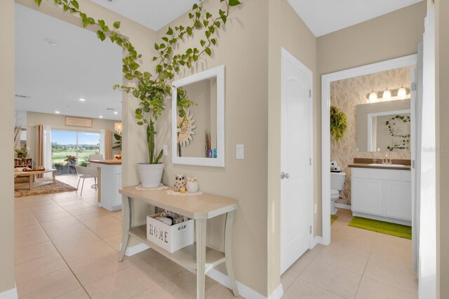 316 Primrose Dr, Davenport, FL 33837 - corridor with a sink, light tile patterned floors, and baseboards