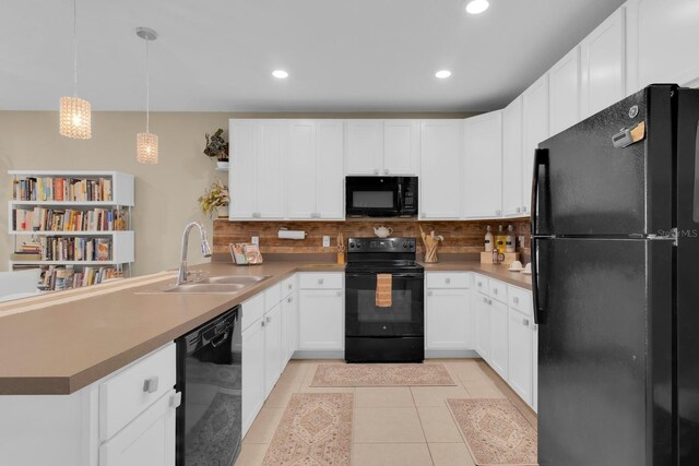 316 Primrose Dr, Davenport, FL 33837 - kitchen with black appliances, a sink, a peninsula, backsplash, and recessed lighting