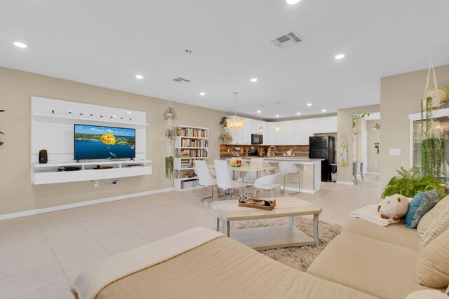 316 Primrose Dr, Davenport, FL 33837 - living area featuring light tile patterned flooring, recessed lighting, and baseboards